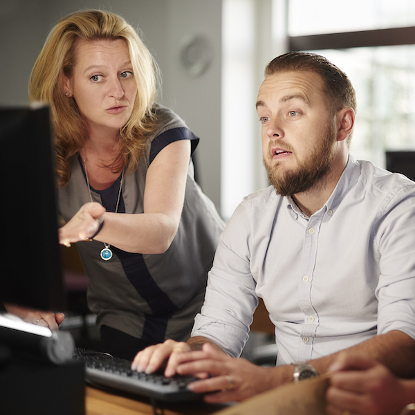 Two people working at a computer