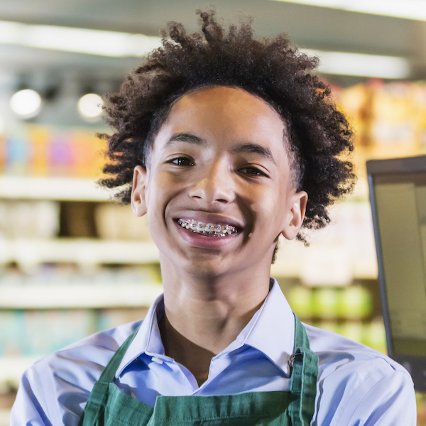 Young adult working at a cash register